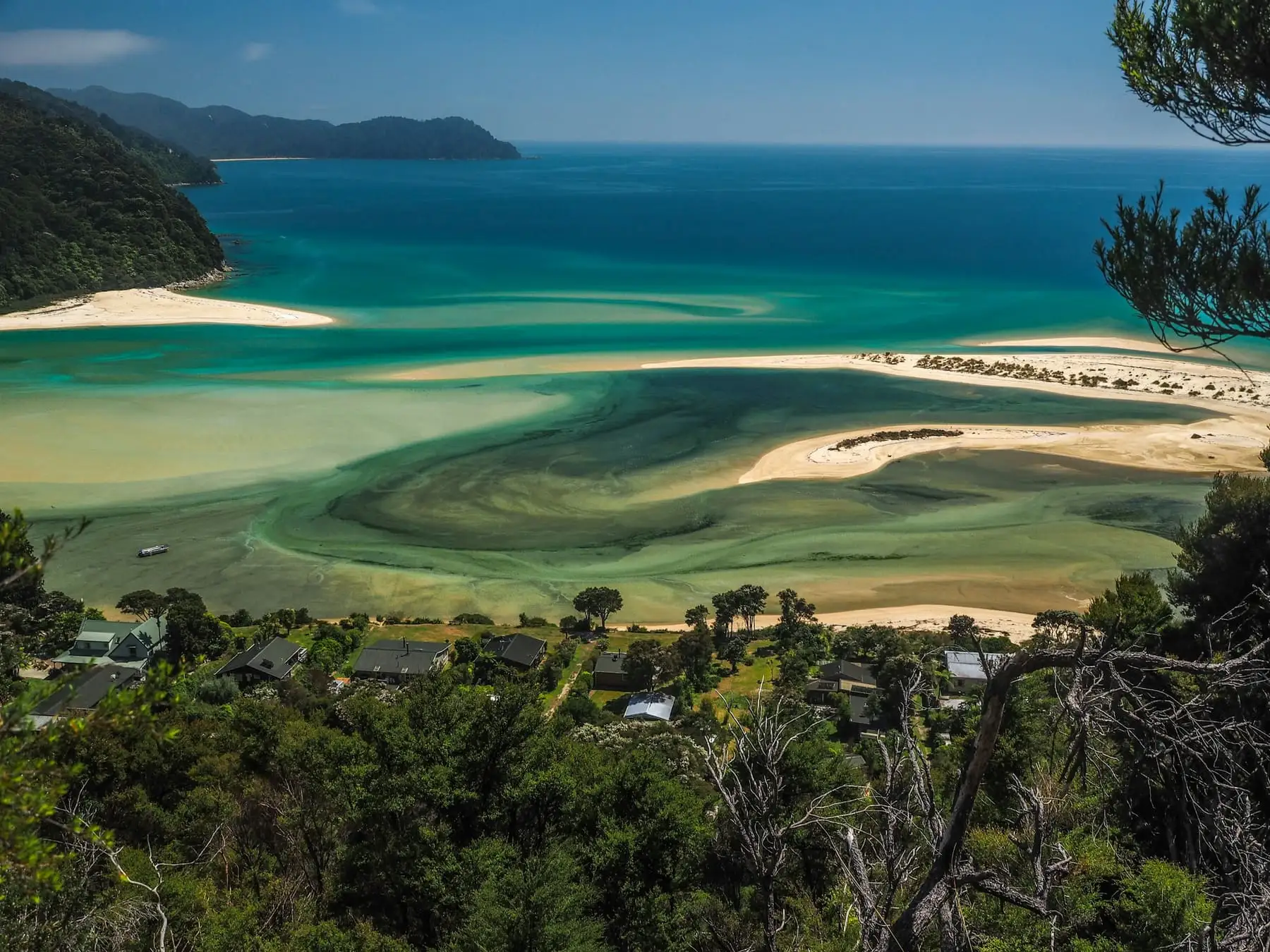 Golden light over the water and headlands of Abel Tasman, New Zealand.